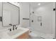 Bathroom featuring a walk-in shower with white tile and a modern vanity with white countertop and black fixtures at 3415 Waxhaw Indian Trail S Rd, Waxhaw, NC 28173