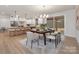 Open dining area adjacent to the kitchen features modern decor and sliding glass doors to the backyard at 3415 Waxhaw Indian Trail S Rd, Waxhaw, NC 28173