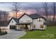 Striking two-story home with a modern aesthetic and a side-entry two-car garage and well kept lawn at 3415 Waxhaw Indian Trail S Rd, Waxhaw, NC 28173