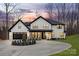 Stunning two-story home with white brick, black trim, circular driveway, and manicured landscaping at 3415 Waxhaw Indian Trail S Rd, Waxhaw, NC 28173