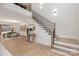 Bright foyer with an open staircase featuring iron railings and wood treads, plus stylish decor at 3415 Waxhaw Indian Trail S Rd, Waxhaw, NC 28173