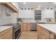 Modern kitchen with white cabinets, stainless steel appliances, and a stylish pot filler at 3415 Waxhaw Indian Trail S Rd, Waxhaw, NC 28173