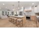 Open-concept kitchen with a large island, modern lighting, stainless steel appliances, and stylish barstools at 3415 Waxhaw Indian Trail S Rd, Waxhaw, NC 28173