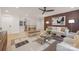 Modern living room features a wood accent wall, decorative ceiling fan, stylish furniture, and hardwood floors at 3415 Waxhaw Indian Trail S Rd, Waxhaw, NC 28173