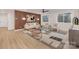 Modern living room features a wood accent wall, decorative ceiling fan, stylish furniture, and hardwood floors at 3415 Waxhaw Indian Trail S Rd, Waxhaw, NC 28173