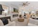 Cozy living room featuring a stone fireplace, stylish furnishings, and modern ceiling fan at 3415 Waxhaw Indian Trail S Rd, Waxhaw, NC 28173