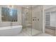 Bright main bathroom with soaking tub, glass enclosed shower, and access to a walk-in closet at 3415 Waxhaw Indian Trail S Rd, Waxhaw, NC 28173