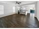 Open living space with kitchen view, hardwood floors, and ceiling fan at 3922 Townes Blvd, Terrell, NC 28682