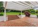 Covered patio with pergola and brick flooring, with steps leading to the green yard and beautiful plants at 430 43Rd Nw Ave, Hickory, NC 28601
