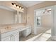 Bright bathroom with double vanity and sinks, gold fixtures, and an open doorway to another room at 430 43Rd Nw Ave, Hickory, NC 28601
