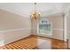 Inviting dining room with hardwood floors, a decorative chandelier, and a large window, offering a bright and airy atmosphere at 430 43Rd Nw Ave, Hickory, NC 28601