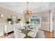 Elegantly staged dining room with a glass table, white chairs, stylish lighting, and decor, creating a refined space at 430 43Rd Nw Ave, Hickory, NC 28601