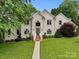Elegant home featuring a lush green lawn, mature landscaping, and a welcoming entrance at 430 43Rd Nw Ave, Hickory, NC 28601