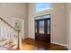Bright foyer featuring hardwood floors, a stained glass front door, staircase, and high ceilings, creating an inviting entrance at 430 43Rd Nw Ave, Hickory, NC 28601