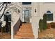 Charming front entrance with brick steps, a decorative glass door, elegant sconces, and manicured greenery, creating curb appeal at 430 43Rd Nw Ave, Hickory, NC 28601