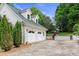 Detached garage offers two bays and a driveway surrounded by green foliage and manicured lawn at 430 43Rd Nw Ave, Hickory, NC 28601