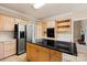Bright kitchen features stainless steel appliances, tile floors, and a large island with black countertops at 430 43Rd Nw Ave, Hickory, NC 28601