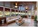 Bright sunroom features a ceiling fan, an outdoor view, and comfortable seating and decor at 430 43Rd Nw Ave, Hickory, NC 28601