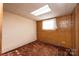 Unfinished basement room with brick and block walls, carpet, and a window at 4745 16Th Street Ne Dr, Hickory, NC 28601