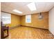Finished basement room with brick walls and wood flooring at 4745 16Th Street Ne Dr, Hickory, NC 28601