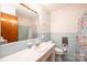 Bathroom with light blue tiled walls and floral shower curtain at 4745 16Th Street Ne Dr, Hickory, NC 28601