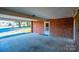 Covered carport with brick walls and concrete flooring at 4745 16Th Street Ne Dr, Hickory, NC 28601