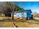 Blue ranch home with a slight hill, landscaping, and trees at 4745 16Th Street Ne Dr, Hickory, NC 28601