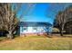 Ranch style home with blue siding, brick accents and mature trees at 4745 16Th Street Ne Dr, Hickory, NC 28601