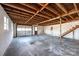 Unfinished garage with concrete floor, large door, and stairs to upper level at 4745 16Th Street Ne Dr, Hickory, NC 28601