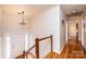 Upper hallway with hardwood floors and access to bedrooms at 4745 16Th Street Ne Dr, Hickory, NC 28601