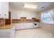 Classic kitchen with white cabinets, wood countertops, and appliances at 4745 16Th Street Ne Dr, Hickory, NC 28601
