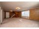 Spacious living room with brick accent wall and carpet flooring at 4745 16Th Street Ne Dr, Hickory, NC 28601