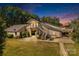 Exterior showing a well-maintained barn with garage space and upper-level living quarters at 795 French Belk Rd, Mt Ulla, NC 28125