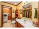 Bathroom with wood vanity, mirror, and adjacent laundry room at 795 French Belk Rd, Mt Ulla, NC 28125