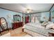 Bedroom with blue walls, four-poster bed, ceiling fan and carpet at 795 French Belk Rd, Mt Ulla, NC 28125