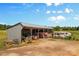A tractor and other farm equipment stored in an open-sided barn under a bright blue sky at 795 French Belk Rd, Mt Ulla, NC 28125