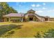 Exterior view showing a charming living space above the garage, with lush landscaping at 795 French Belk Rd, Mt Ulla, NC 28125