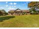 Charming brick home with a large front yard and welcoming covered porch at 795 French Belk Rd, Mt Ulla, NC 28125