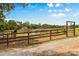 Horse paddock with animal and equipment is surrounded by split rail fencing under a sunny sky at 795 French Belk Rd, Mt Ulla, NC 28125