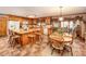 Traditional eat-in kitchen with wood cabinetry, island, tile floors, and breakfast area at 795 French Belk Rd, Mt Ulla, NC 28125