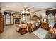 A charming bedroom with fireplace, warm carpet, a ceiling fan, and soft natural light at 795 French Belk Rd, Mt Ulla, NC 28125