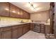 Elegant bar area with custom cabinets, tiled backsplash, a sink, and a wine cooler for entertaining guests at 990 19Th Nw Ave, Hickory, NC 28601