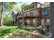 A multi-level house with a brick facade, multiple patios, and a grassy backyard at 990 19Th Nw Ave, Hickory, NC 28601