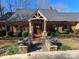 Charming brick home features a welcoming front porch, mature landscaping, and a well-manicured lawn at 990 19Th Nw Ave, Hickory, NC 28601