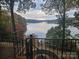 Scenic lake view from a deck with a fire pit and black iron railing at 990 19Th Nw Ave, Hickory, NC 28601