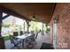 Charming covered patio with brick flooring, outdoor seating, and scenic views of the surrounding landscape at 990 19Th Nw Ave, Hickory, NC 28601