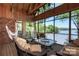 Relaxing screened porch featuring comfortable seating, a hammock, and beautiful views of the lake at 990 19Th Nw Ave, Hickory, NC 28601