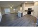 Open living room and kitchen with grey laminate flooring at 1014 N Main St, China Grove, NC 28023