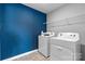 Laundry room with washer, dryer, and blue accent wall at 1024 20Th Avenue Se Way, Hickory, NC 28602