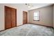 Bright bedroom with wood closet doors and carpeted floors at 1061 Woodlake Ln, Tega Cay, SC 29708